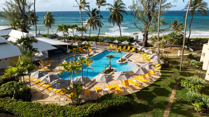 Resort pool with ocean in the background.