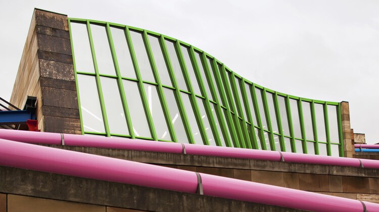 Exterior of Staatsgalerie with wavy windows and pink hand rails
