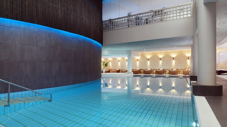 calm aqua colored pool with adjacent lounge area