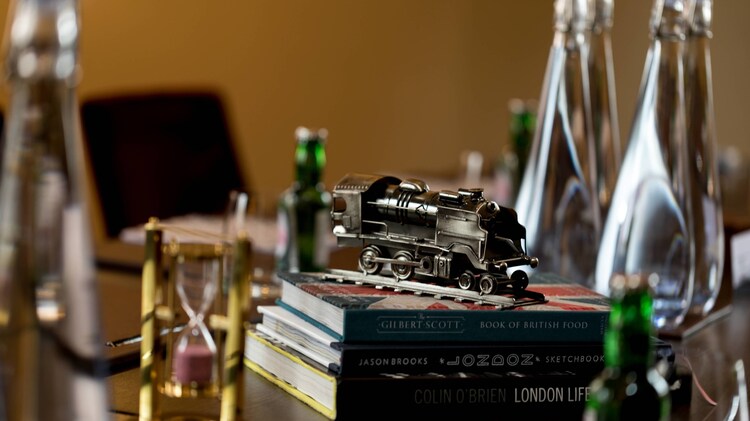Closeup of a model train engine sitting on a stack of books.