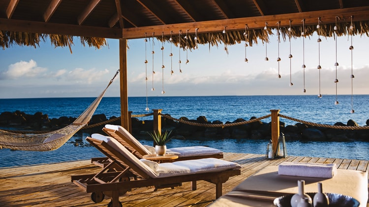 Okeanos spa beach cabanas with lounge chairs and ocean views