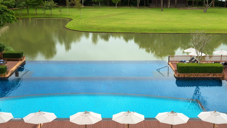The Outdoor pool area sits adjacent to beautiful scenery.