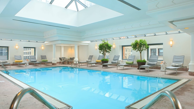 Indoor pool with deck chairs