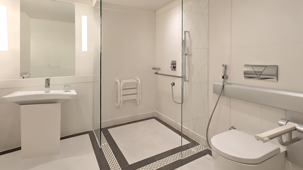 Banheiro para hóspedes com mobilidade reduzida – chuveiro para cadeira de rodas