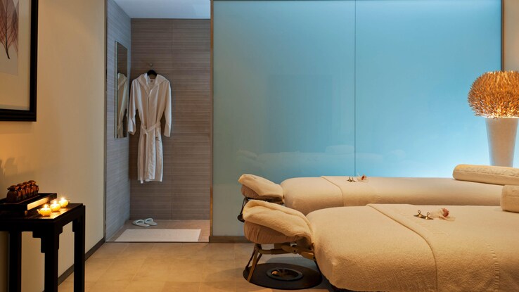 Spa massage table in corner of calming room.