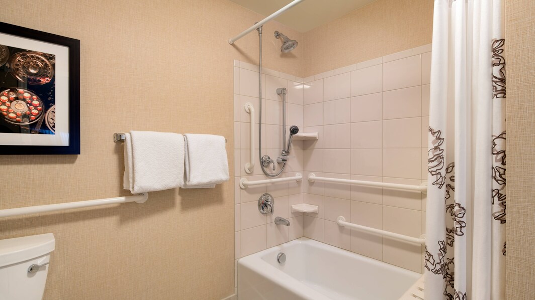 Ванная комната с ванной с поручнями для гостей с ограниченными возможностями