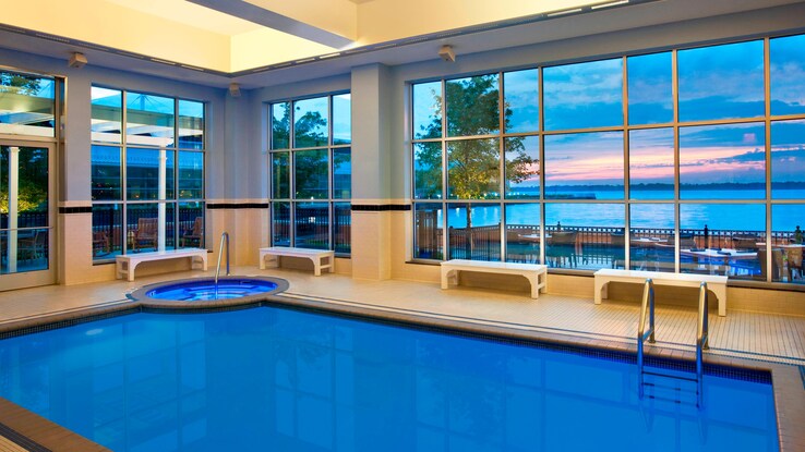 Indoor pool with high windows overlooking the bay.