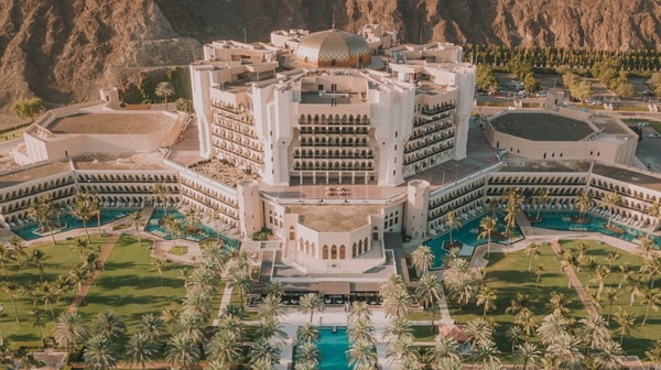 Aerial view of Al Bustan Palace, A Ritz-Carlton Hotel and surrounding mountains