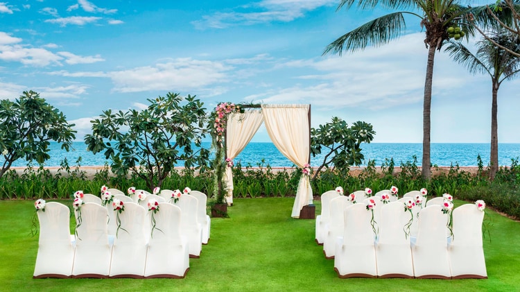 Lawn set with chairs for wedding ceremony.