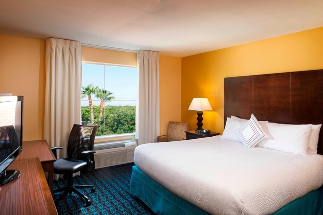 King guest room bed and desk IAH hotels 
