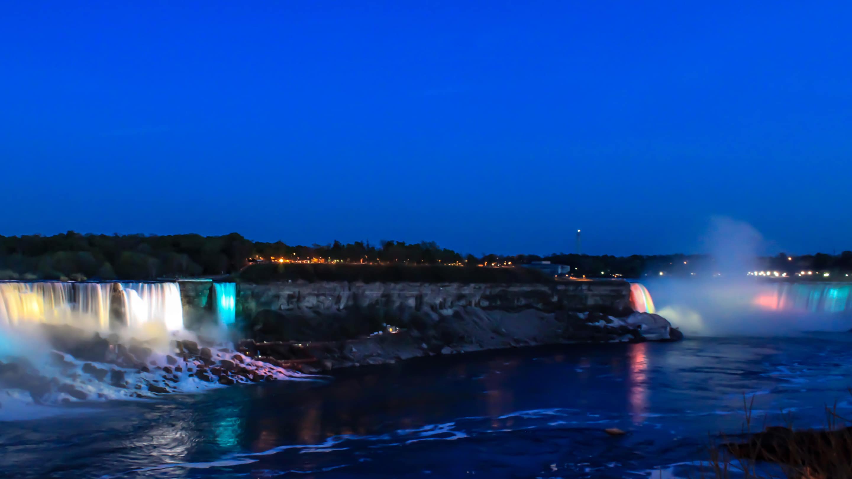 Niagara Falls lit up at night.