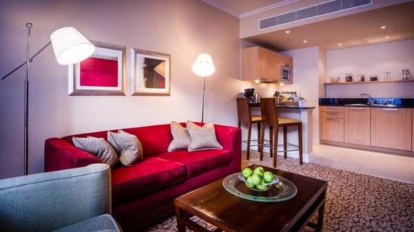 Suite with full kitchen, sofa, table and lamp