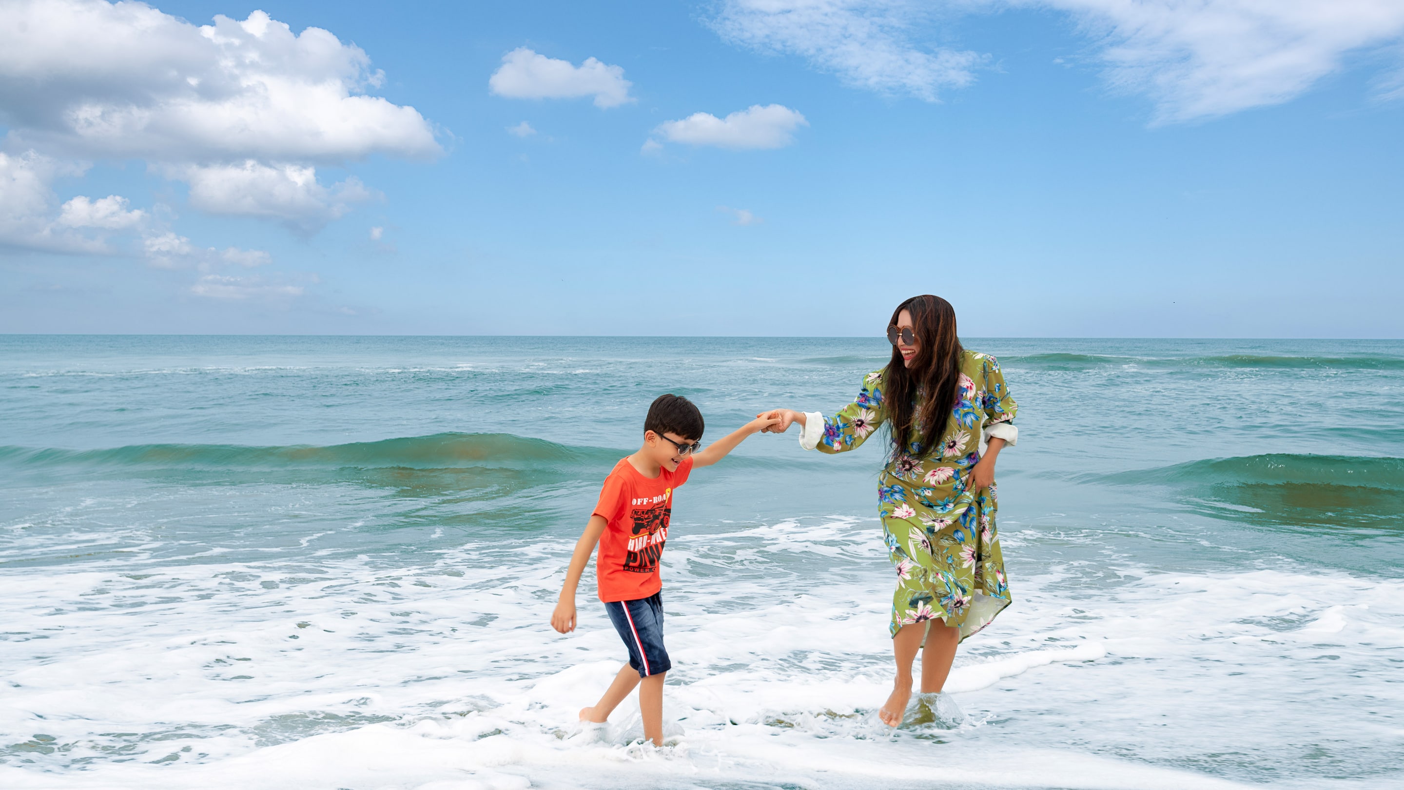 Mother And Son Playing At Beach