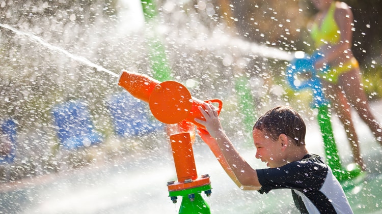Boy playing with water cannon.