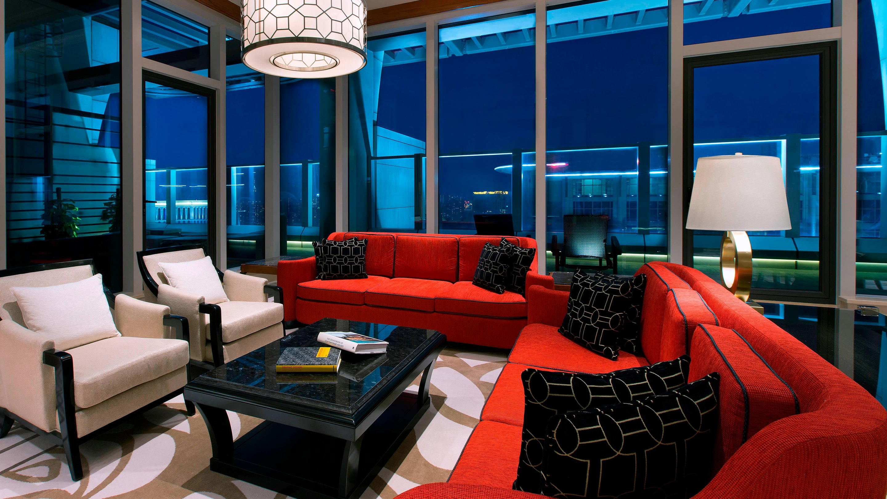 Terrace suite living area with seating and red couches