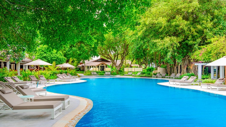 Outdoor Freshwater Swimming Pool with poolside lounge chairs.