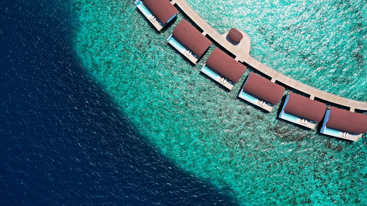 Overwater suites with wooden walkway and surrounding water