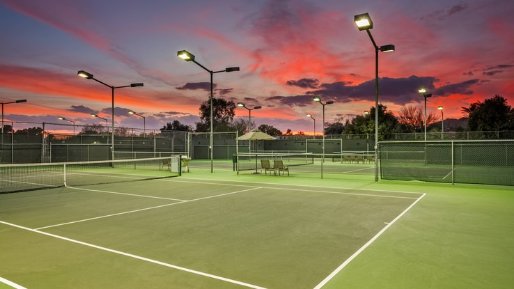 Outdoor tennis courts at night