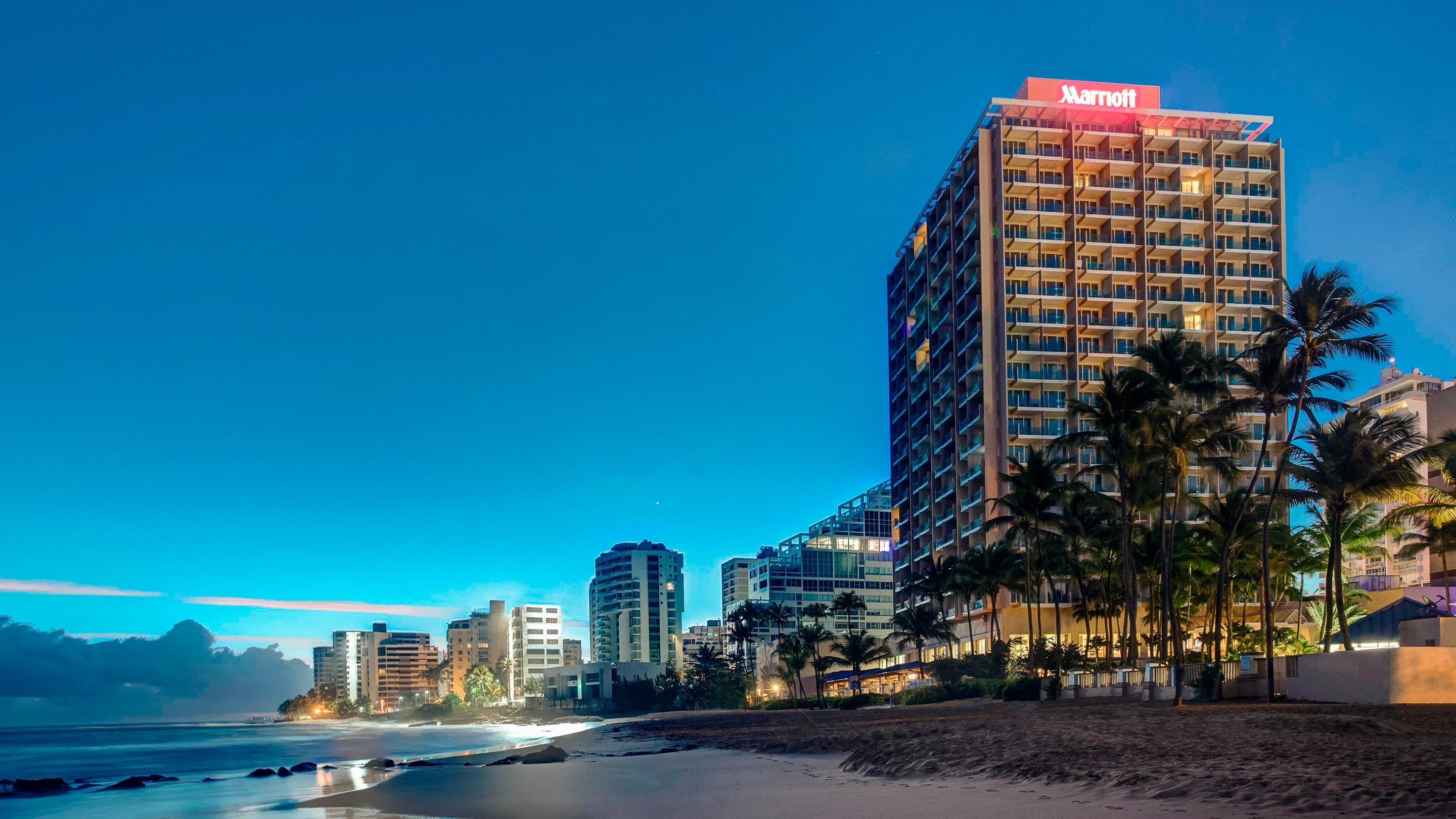 Exterior of hotel and beach at night