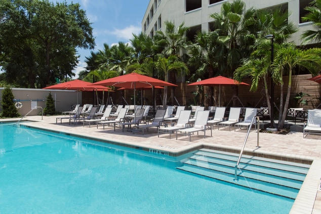 A Tampa pool with chairs and umbrellas