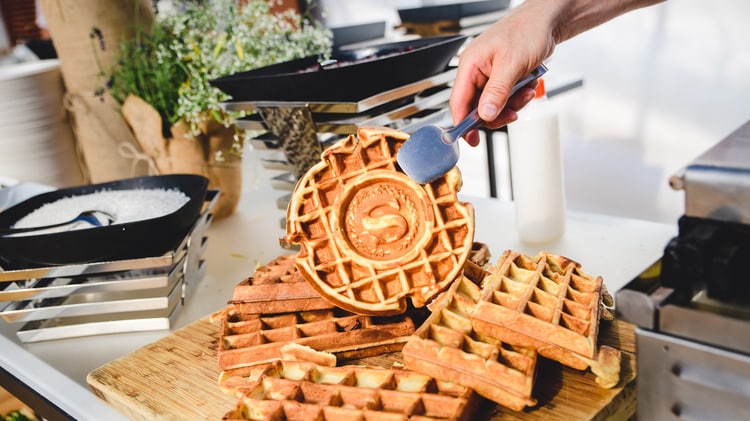 Plate of waffles being served.