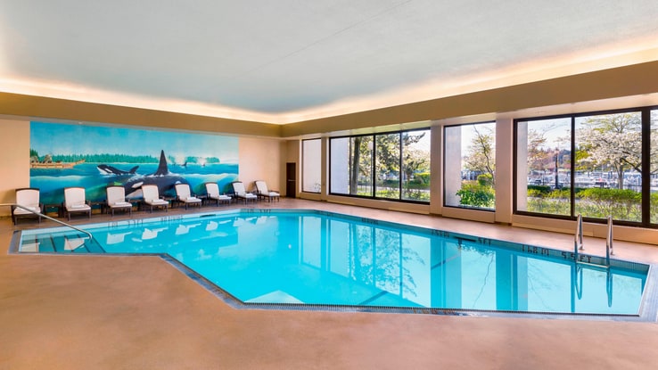 Indoor pool with poolside seating.
