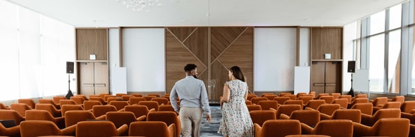 Two people in a conference room with chairs