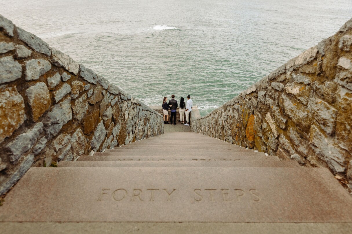 People standing on stairs by the water