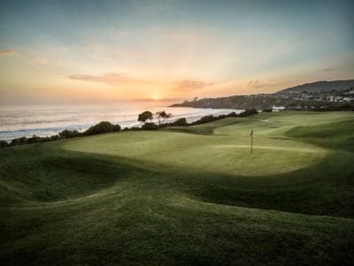 Ocean-view golf course at sunset