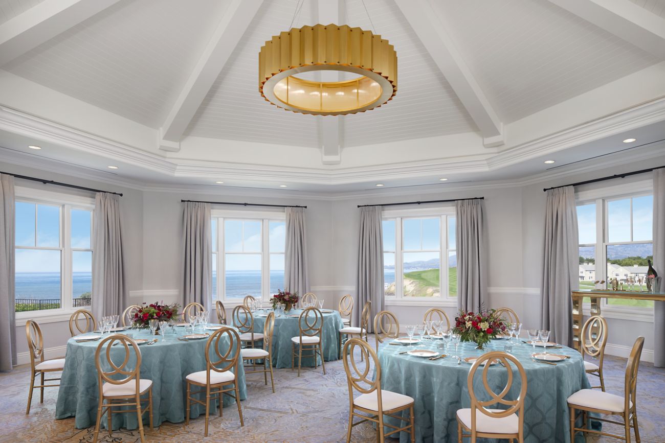 Room with a domed ceiling, large windows and banquet tables