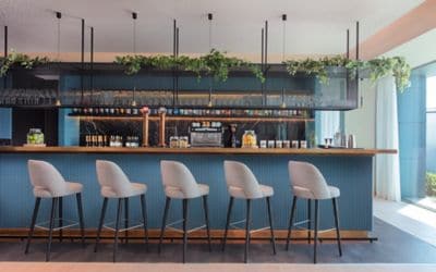 Modern hotel bar with blue colors and grey chairs