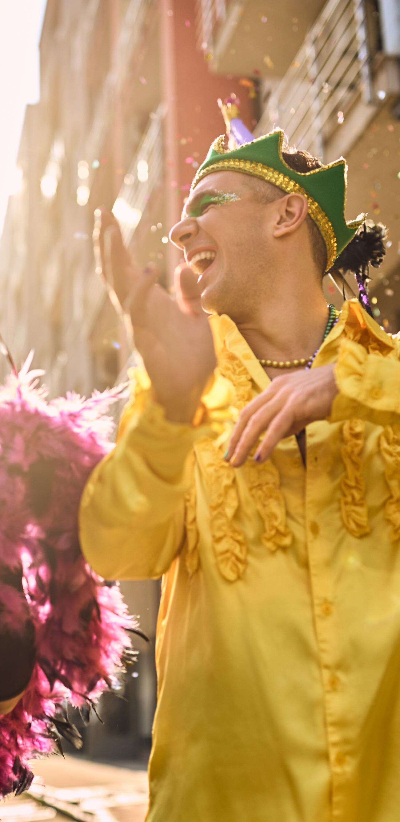 Cheerful friends having fun and dancing on Brazilian carnival parade on the street.