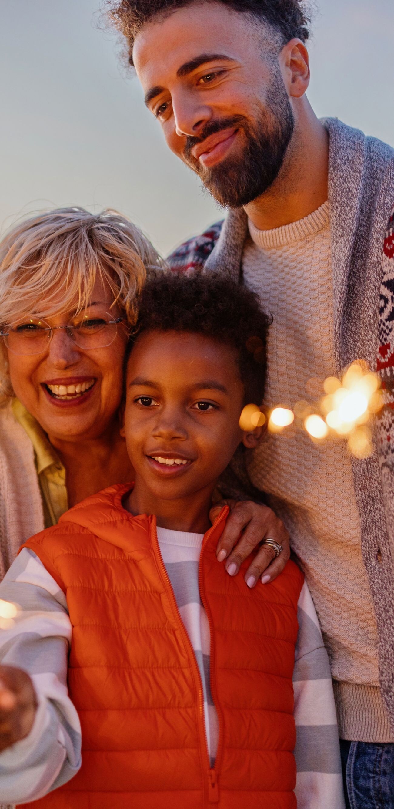 Multi-generation family celebrating Christmas on the beach
