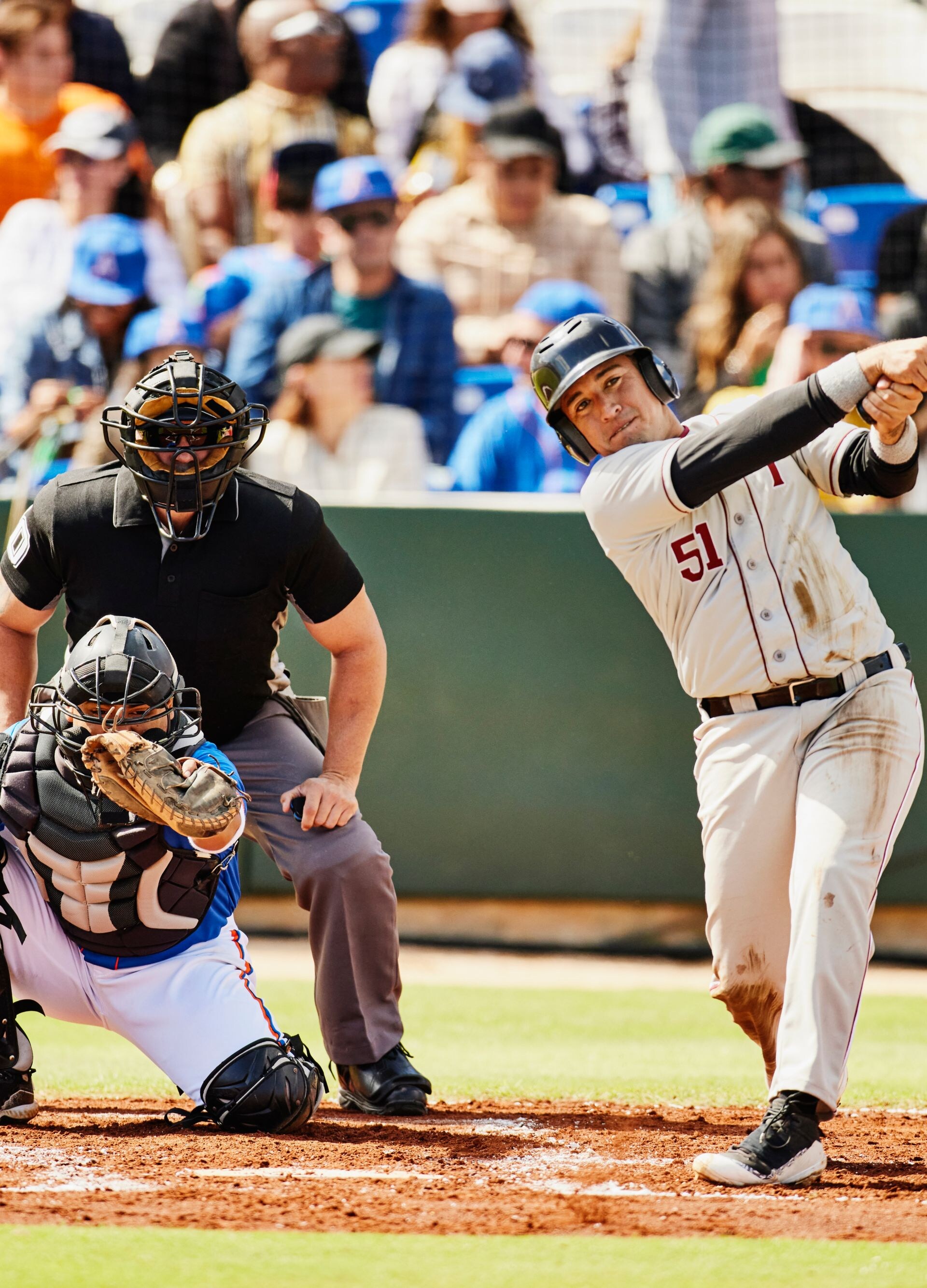 Wide shot batter watching hit during at-bat in baseball game