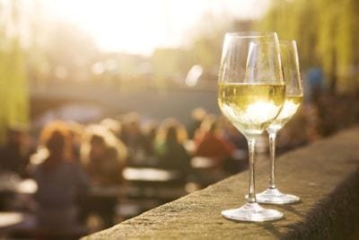 Alcohol, Back Lit, Bar, Behind, Bridge, Bright, Brightly Lit, Cafe, Cafe Culture, Chardonnay Grape, City, City Life, City Street, Copy Space, Dating, Drink, Drinking, Dusk, Europe, Focus On Foreground, Glass, Glass, Green, Horizontal, Lifestyles, Outdoors, Patio, People, People In The Background, Restaurant, Romance, Shiny, Sidewalk Cafe, Sitting, Spring, Stone, Street, Summer, Summer Terrace, Sun, Sunlight, Sunset, Tranquil Scene, Tree, Two Objects, Unrecognizable Person, Urban Scene, White Wine, Wine, Wineglass, Yellow