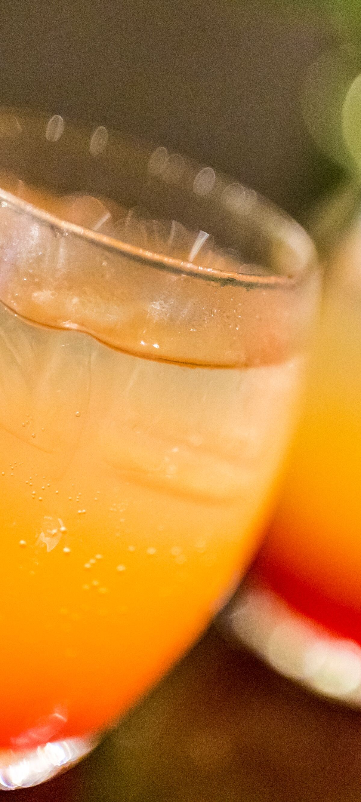 Close-up of two glasses of Tequila sunrise cocktails just waiting to be savoured.