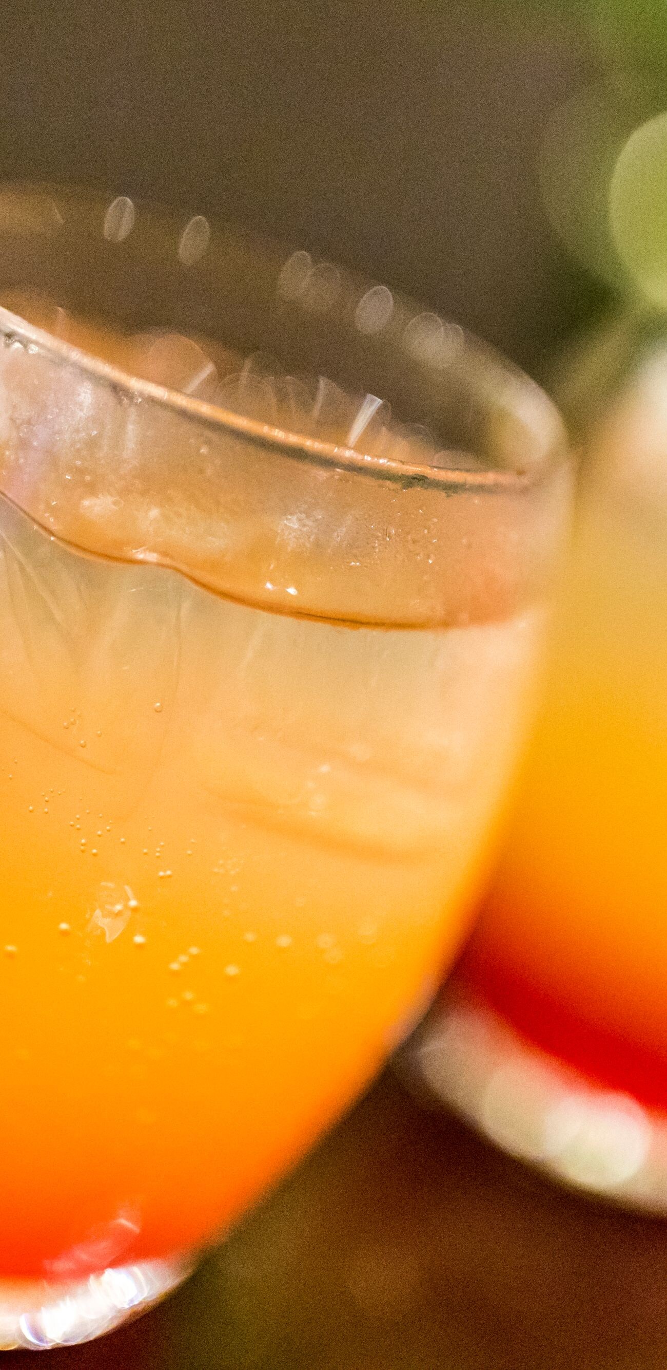 Close-up of two glasses of Tequila sunrise cocktails just waiting to be savoured.