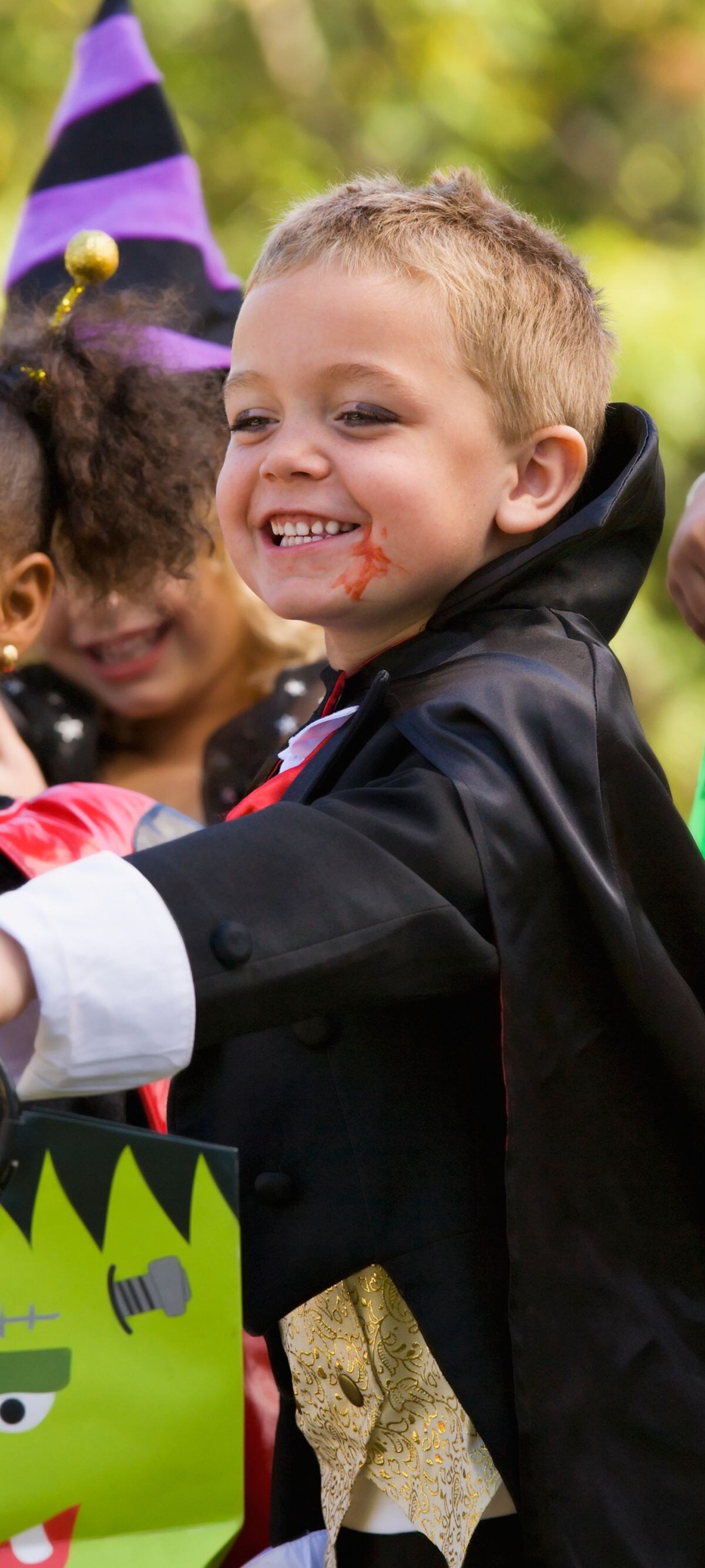 4-5 years, 6-7 years, african ethnicity, asian ethnicity, bag, basket, boy, caucasian, childhood, children, color image, costume, day, diversity, elementary age, friend, front view, girl, halloween, holding, holiday, horizontal, imagination, latin american and hispanic ethnicity, medium group of people, multi-ethnic group, outdoors, party, people, photography, preschooler, standing, trick or treat, waist up
