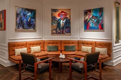 three large art pieces and large sofa