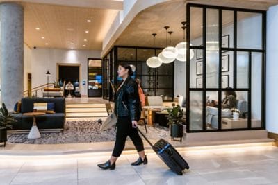 Woman walking into a hotel lobby.