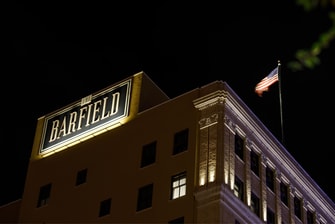 The Barfield building sign at night.