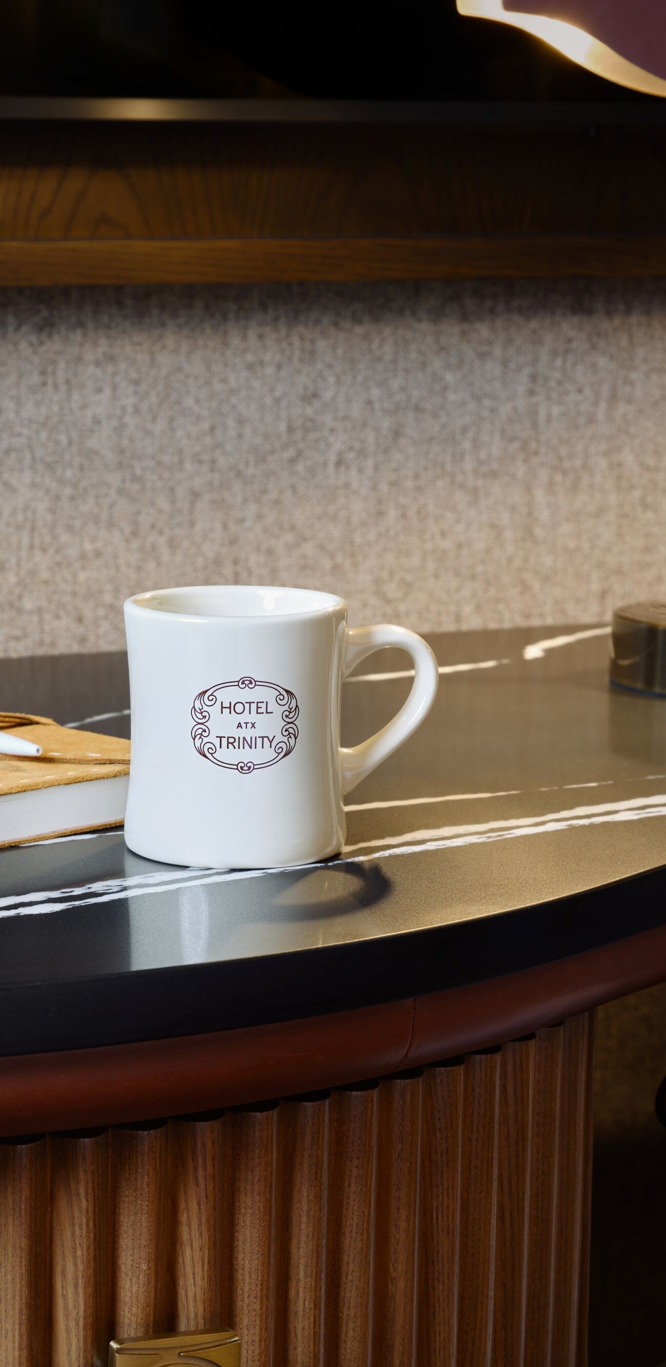 Coffee mug on hotel room desk with pad of paper