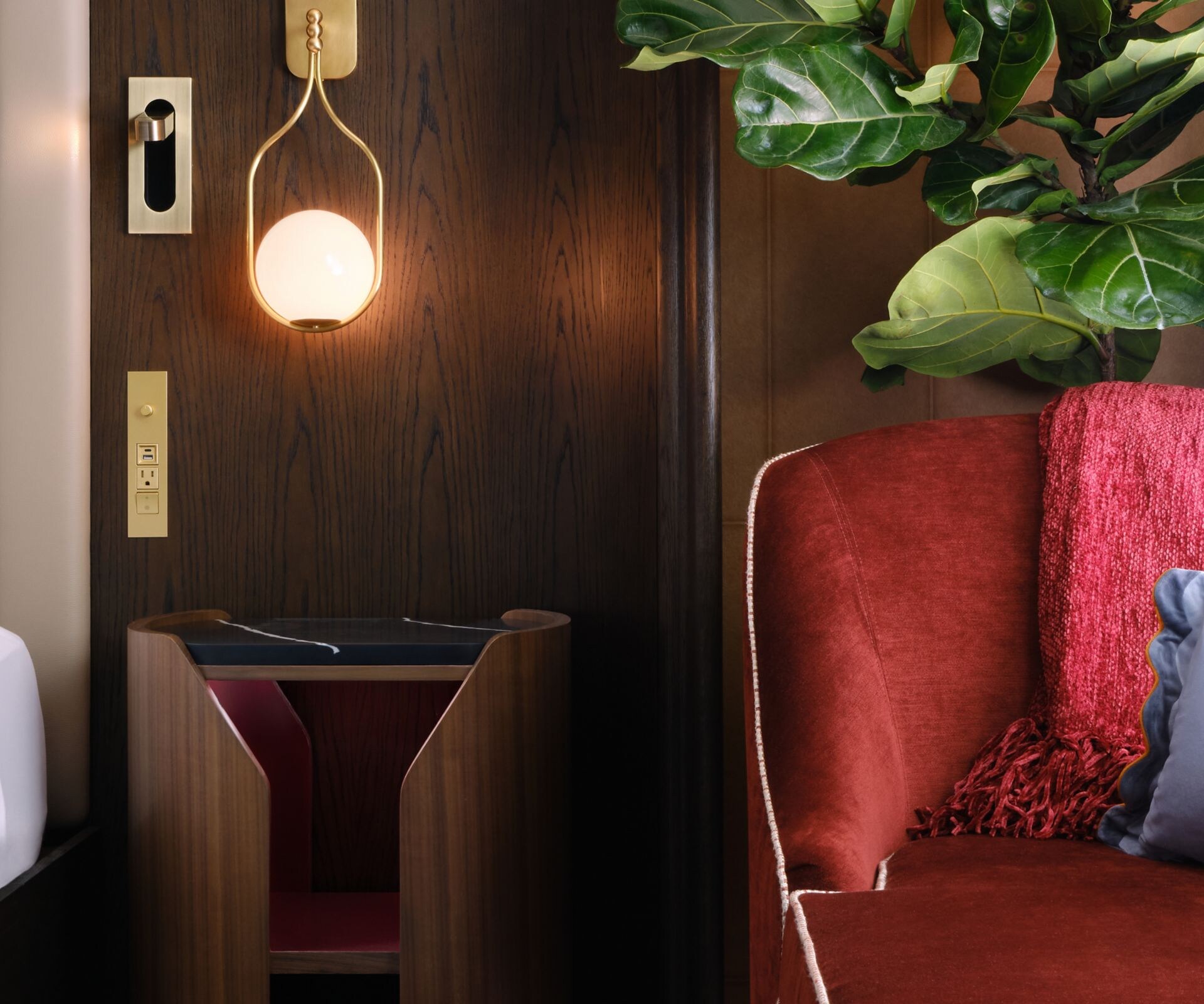 Chaise lounge next to bed with table between