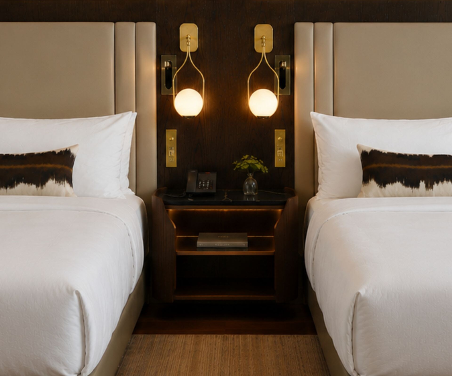 two queen beds with nightstand between