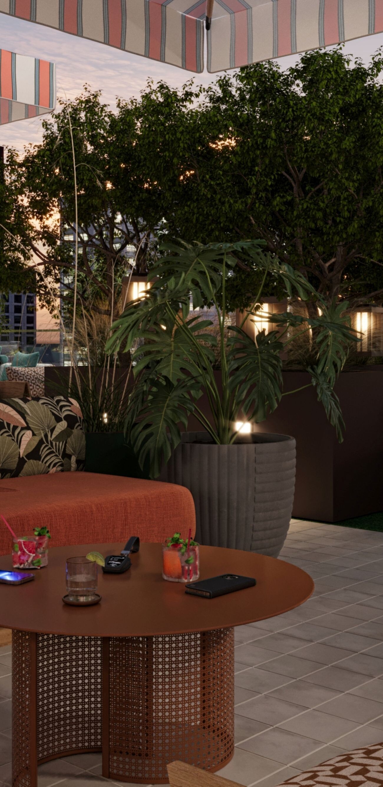 Couch and table on rooftop with greenery around
