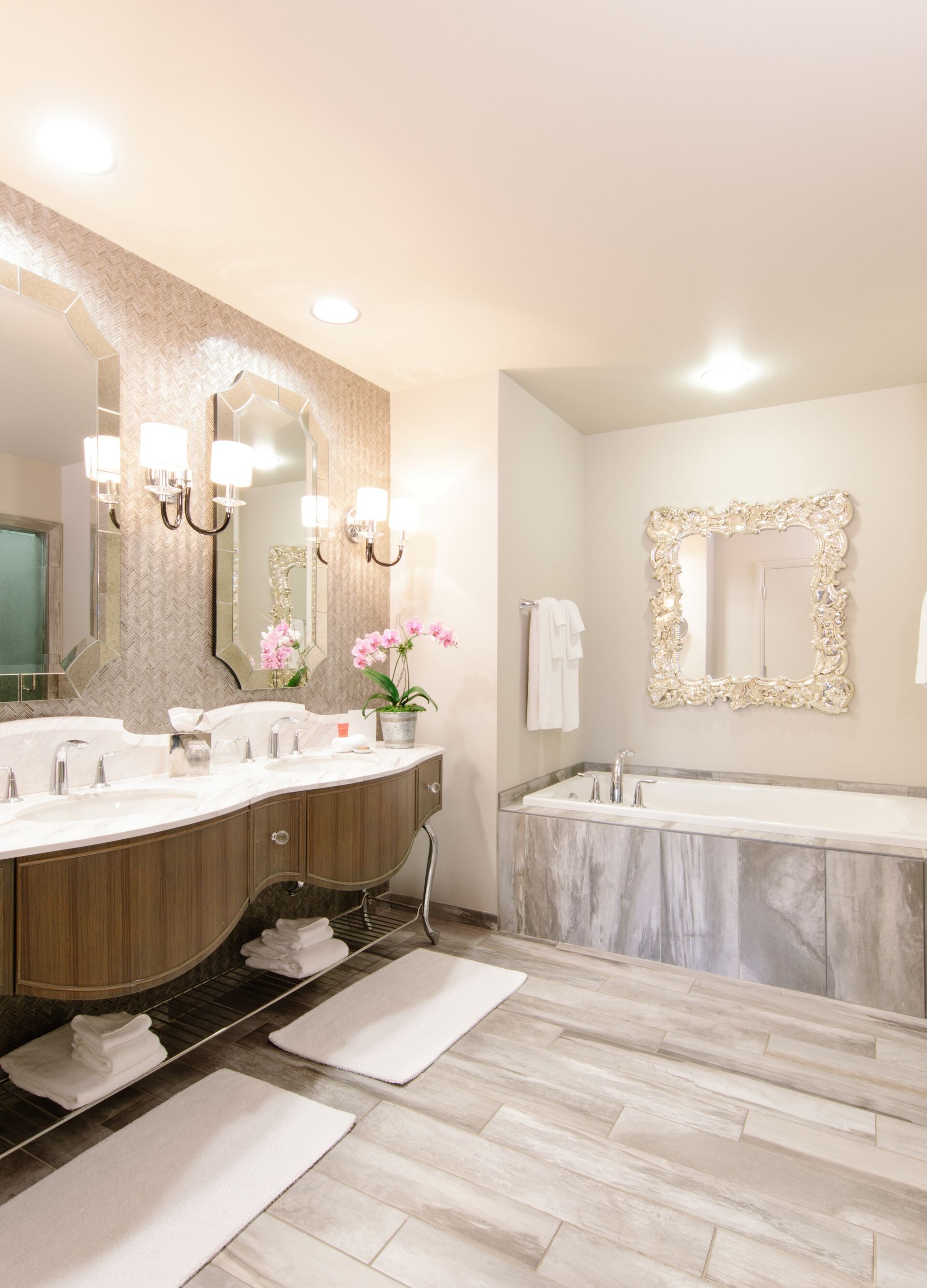 Bathroom with marble tub and dual vanity