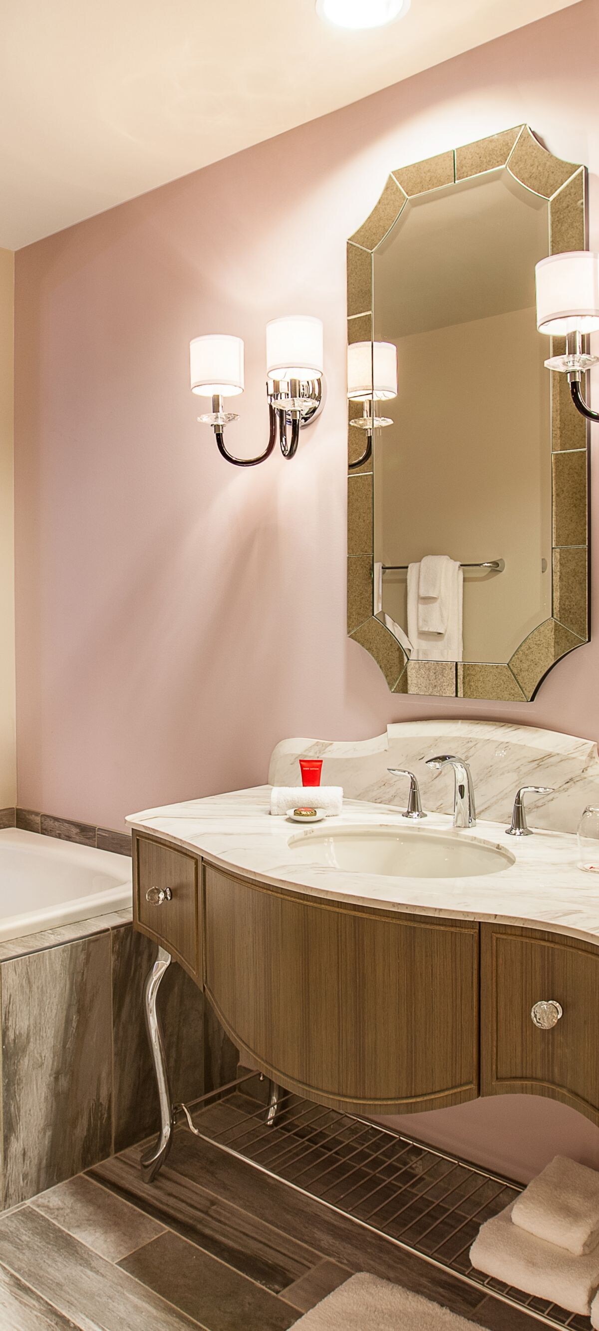 Bathroom with marble vanity and deep tub