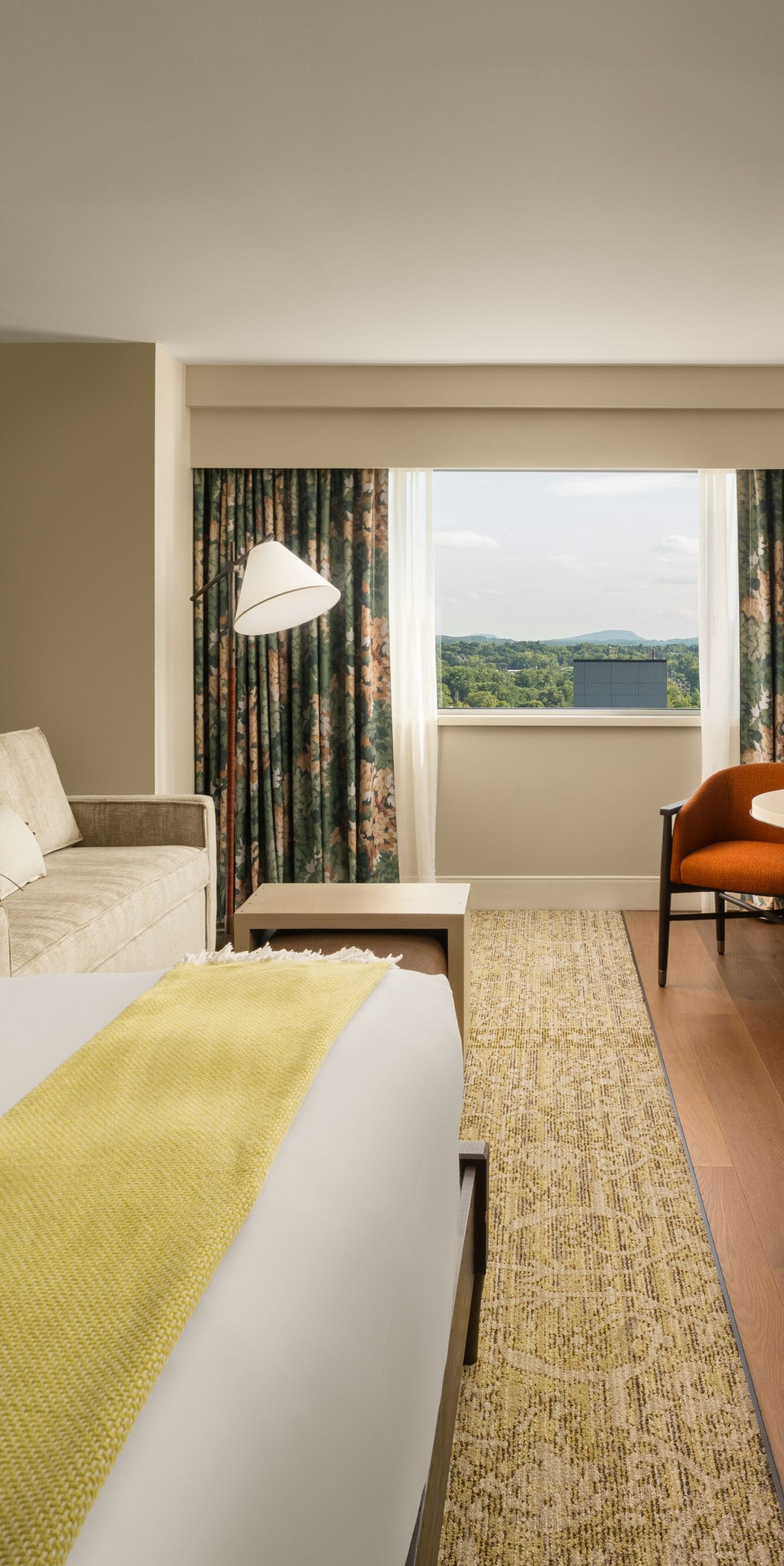 Guest room with king bed, couch, tv, and lamps