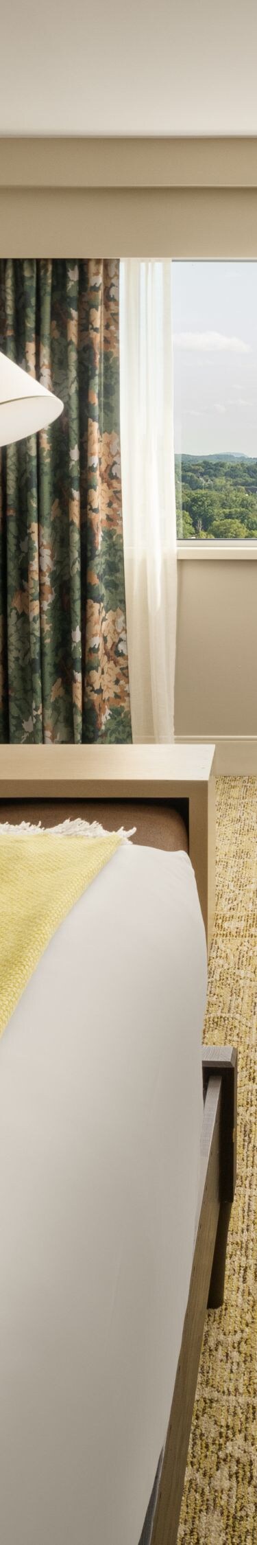 Guest room with king bed, couch, tv, and lamps