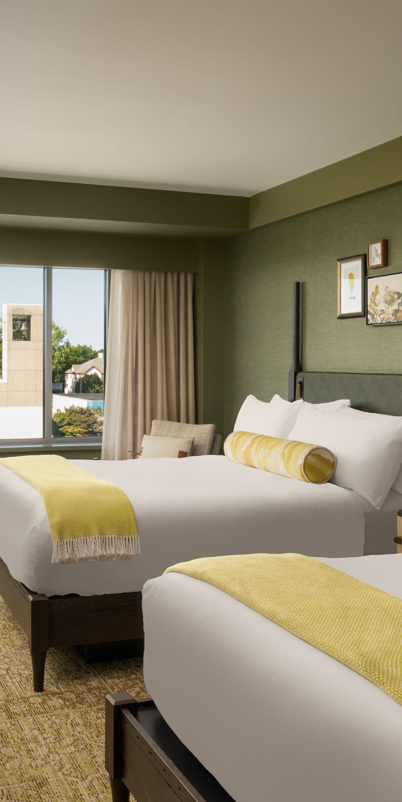 room with two queen beds and sitting area